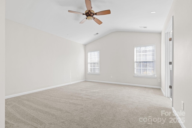 carpeted empty room featuring lofted ceiling and ceiling fan