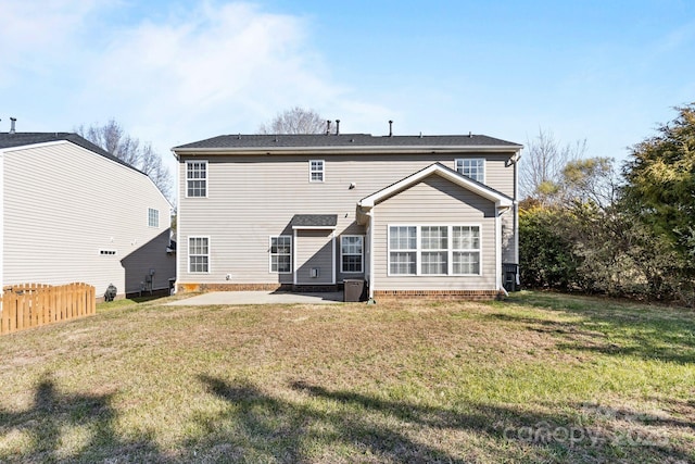 back of house with a patio and a yard