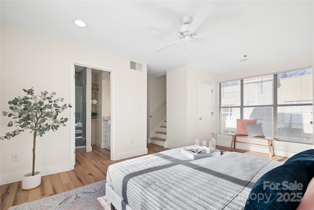 bedroom with ceiling fan, hardwood / wood-style floors, and connected bathroom