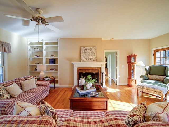 living room with ceiling fan and light hardwood / wood-style flooring