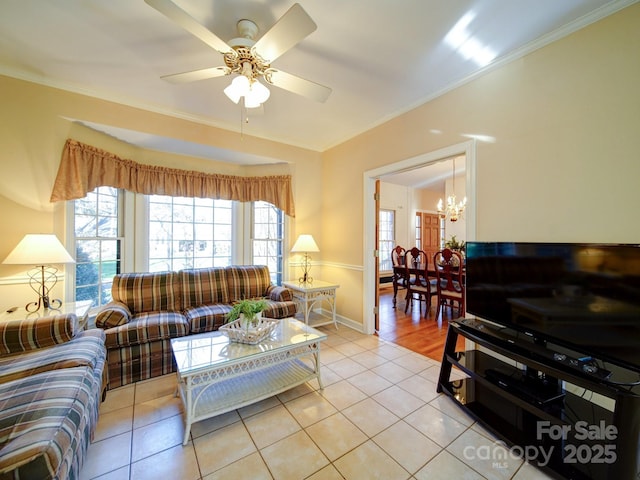 living room featuring light tile patterned flooring, ceiling fan with notable chandelier, and ornamental molding