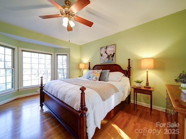 bedroom featuring ceiling fan and dark hardwood / wood-style floors