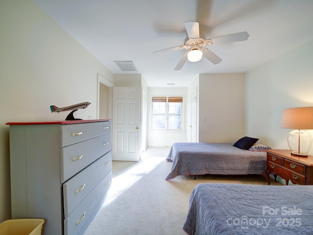 bedroom featuring ceiling fan and light carpet