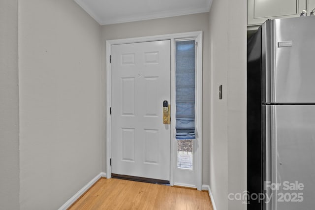 foyer featuring crown molding and light hardwood / wood-style flooring