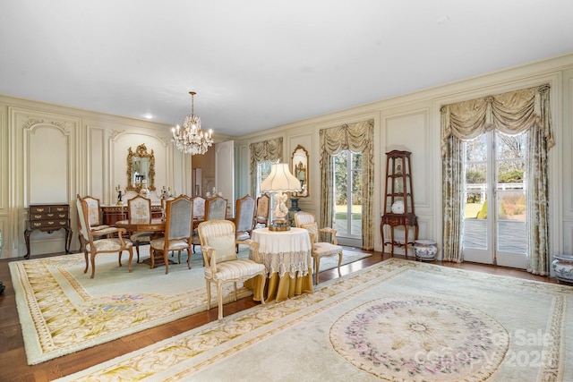 sitting room with a notable chandelier and hardwood / wood-style floors