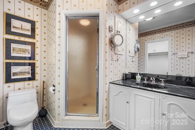 bathroom featuring vanity, toilet, a shower with door, crown molding, and tile patterned floors