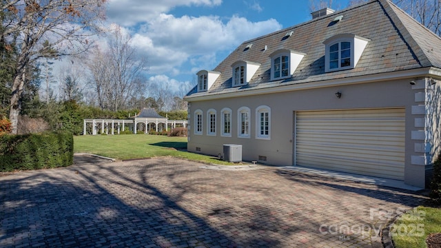 back of house with cooling unit, a yard, a garage, and a gazebo