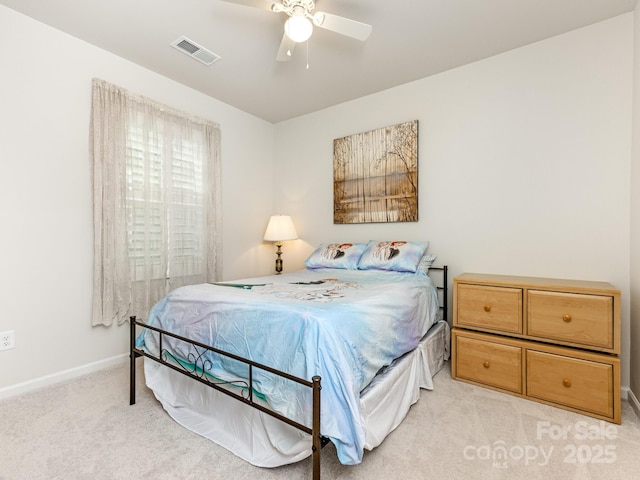 bedroom featuring ceiling fan and light carpet