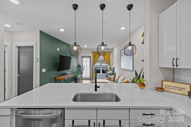 kitchen featuring sink, decorative light fixtures, white cabinetry, dishwasher, and light stone counters