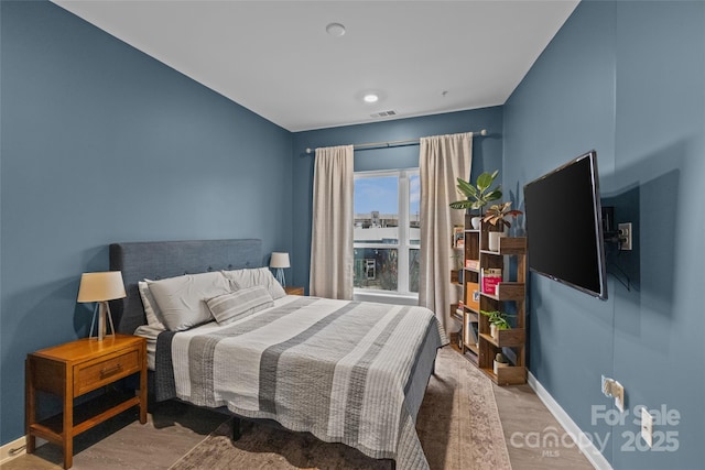 bedroom with wood-type flooring