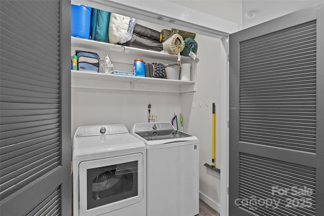 laundry room with separate washer and dryer and hardwood / wood-style floors