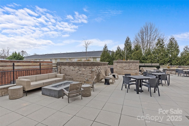 view of patio / terrace featuring an outdoor living space with a fire pit