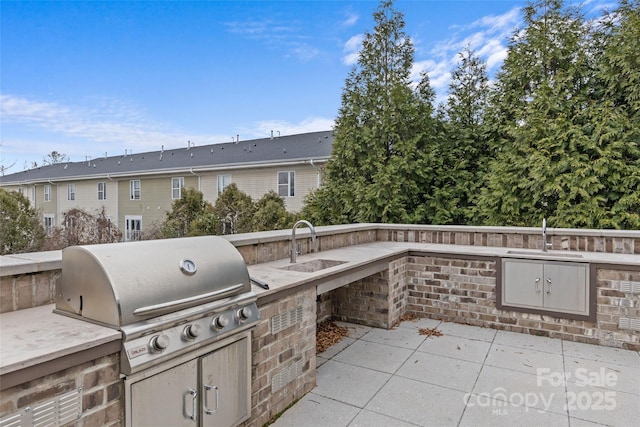 view of patio / terrace featuring sink, a grill, and area for grilling