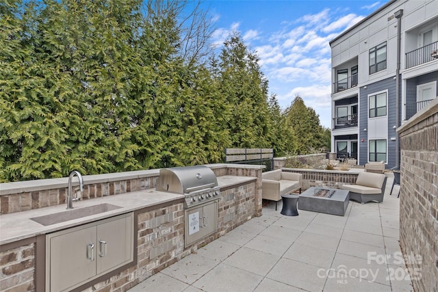 view of patio / terrace featuring sink, a fire pit, and area for grilling