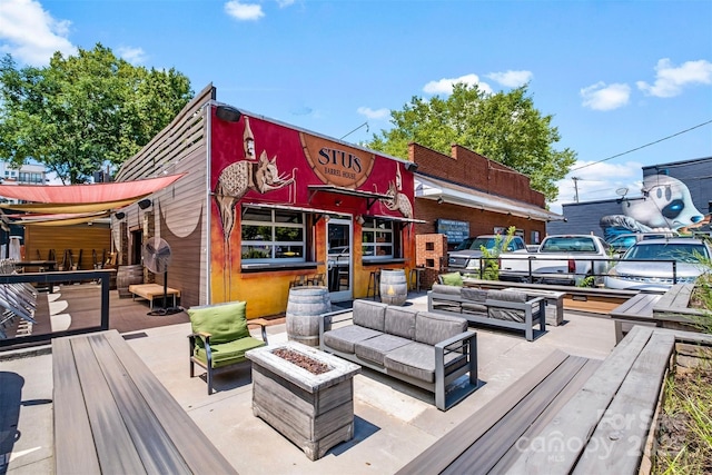 wooden deck with an outdoor living space with a fire pit