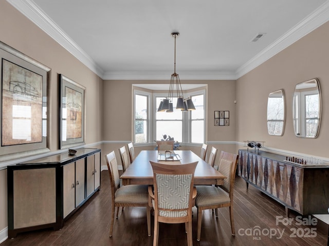 dining space featuring dark hardwood / wood-style flooring and ornamental molding