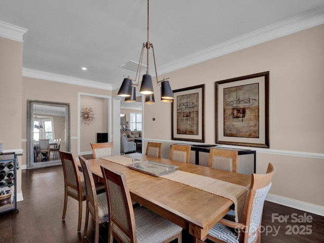 dining room featuring an inviting chandelier, dark hardwood / wood-style flooring, and crown molding