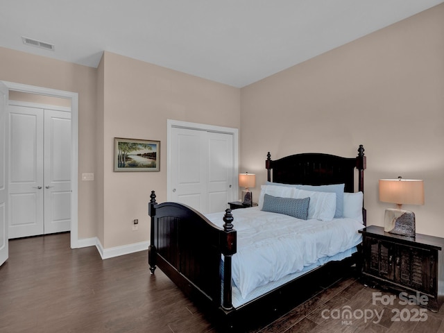 bedroom with a closet and dark hardwood / wood-style flooring