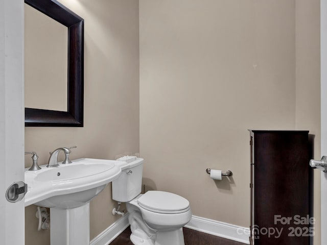 bathroom featuring toilet and hardwood / wood-style flooring