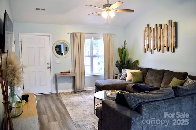 living room featuring ceiling fan, lofted ceiling, and hardwood / wood-style flooring