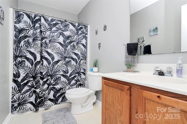 bathroom featuring tile patterned floors, vanity, and toilet