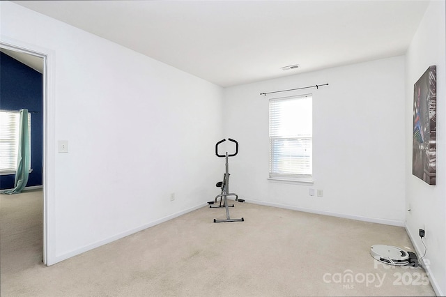 workout area with light carpet and a healthy amount of sunlight