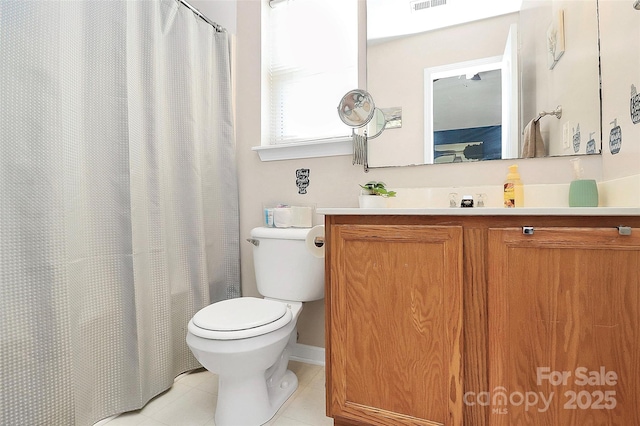 bathroom with tile patterned flooring, vanity, and toilet