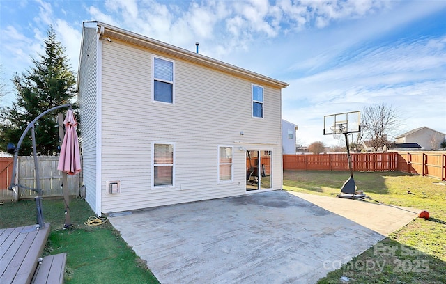 rear view of house featuring a yard and a patio