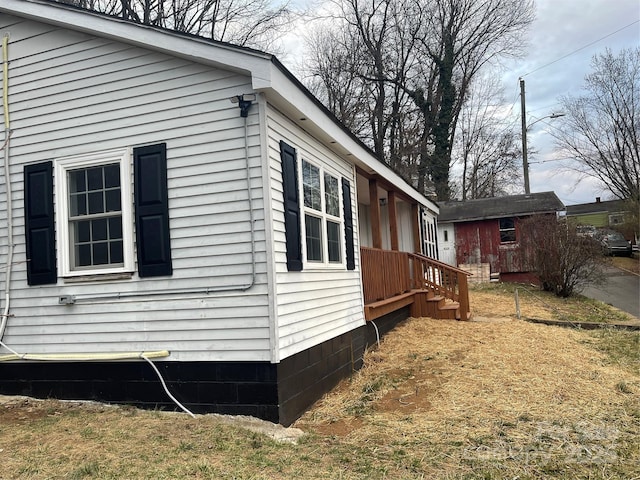 view of side of property with a storage unit