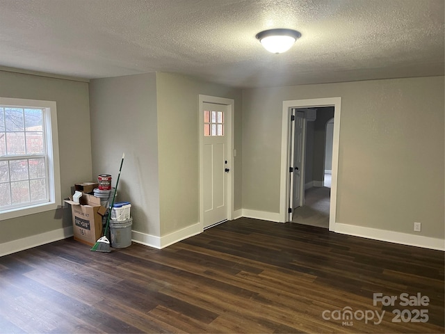 entrance foyer featuring dark hardwood / wood-style floors and a textured ceiling