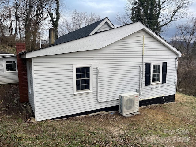 view of property exterior featuring a yard and ac unit