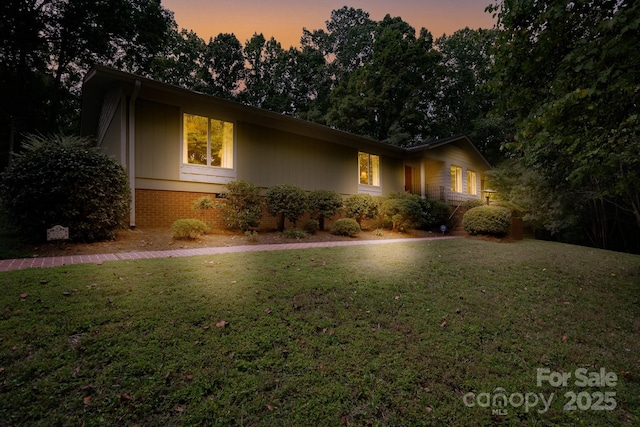 ranch-style home with a yard