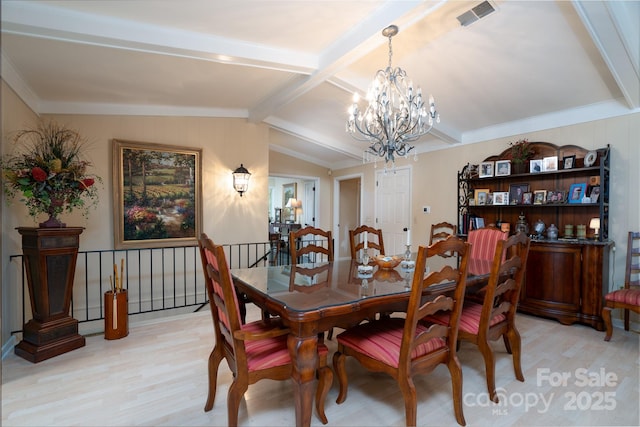 dining room featuring vaulted ceiling with beams, light hardwood / wood-style flooring, and a chandelier