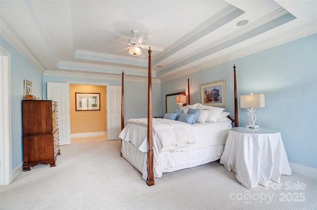 carpeted bedroom with crown molding, ceiling fan, and a tray ceiling