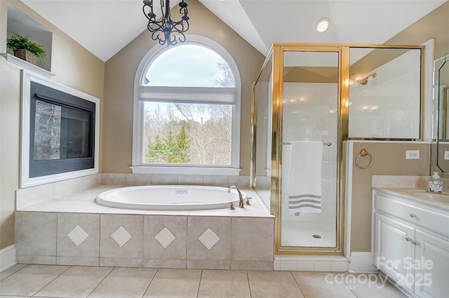 bathroom featuring lofted ceiling, vanity, tile patterned floors, and independent shower and bath