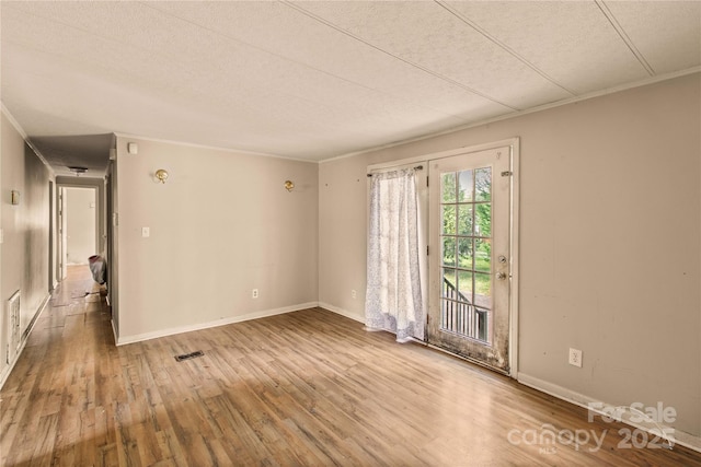 empty room featuring hardwood / wood-style floors and a textured ceiling