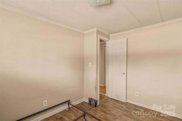 unfurnished bedroom featuring crown molding and dark hardwood / wood-style floors