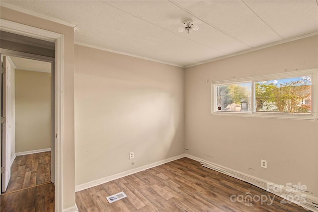 unfurnished room with dark hardwood / wood-style floors and crown molding