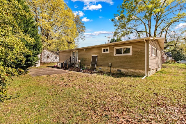 back of property with a patio area and a lawn