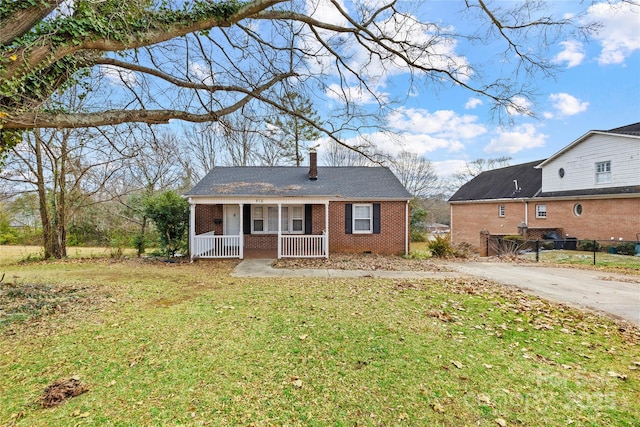 view of front of house featuring a front yard and covered porch