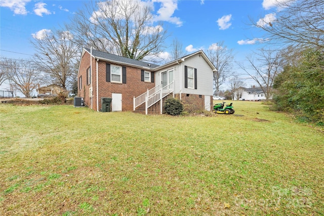 rear view of property with a lawn and cooling unit