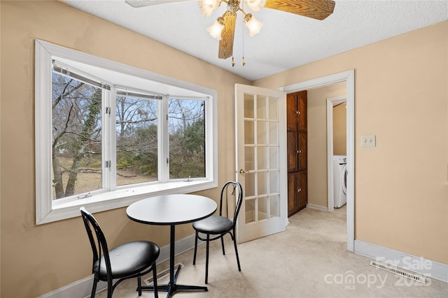 carpeted dining area featuring washer / dryer, a textured ceiling, french doors, and ceiling fan