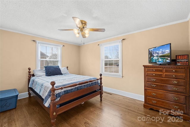 bedroom featuring ceiling fan, multiple windows, and crown molding