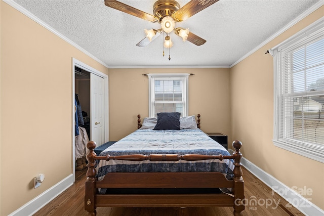 bedroom featuring ceiling fan, dark hardwood / wood-style flooring, and ornamental molding