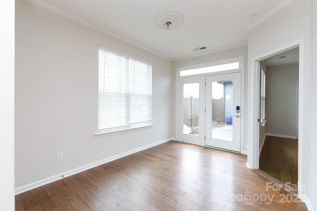 interior space featuring wood-type flooring and ornamental molding