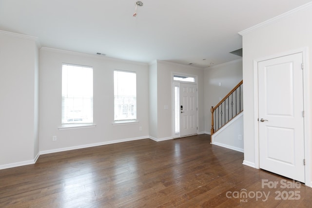 entryway featuring dark wood-type flooring and crown molding