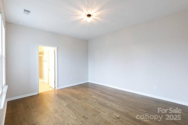 empty room with wood-type flooring