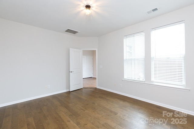 empty room with dark hardwood / wood-style floors