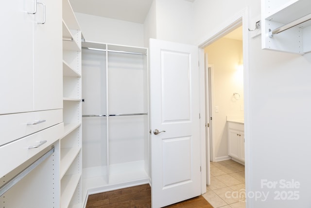 spacious closet with light tile patterned floors