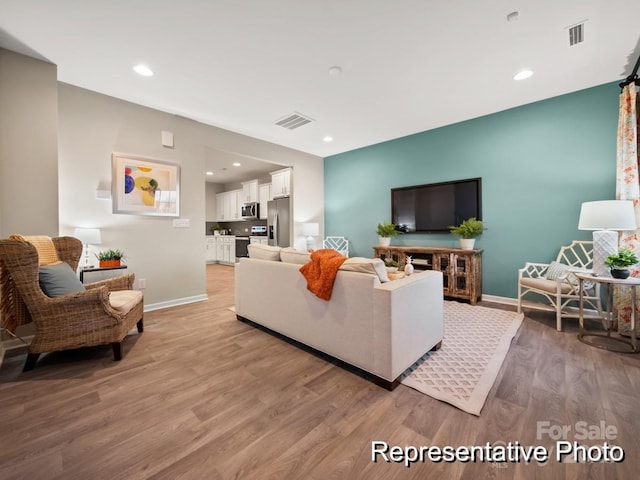 living room with light hardwood / wood-style floors